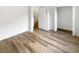 Bedroom featuring wood-look floors and neutral paint, with an adjacent open closet at 1238 Standridge Dr, Wesley Chapel, FL 33543