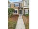 Charming tan two-story townhome with a well-manicured lawn and a welcoming entryway at 1238 Standridge Dr, Wesley Chapel, FL 33543