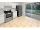 Cozy kitchen featuring a stainless steel refrigerator and a view of the enclosed lanai at 1238 Standridge Dr, Wesley Chapel, FL 33543
