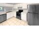 Bright kitchen featuring stainless steel appliances and white cabinetry at 1238 Standridge Dr, Wesley Chapel, FL 33543