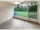 Screened in lanai with views of the green backyard, and door to the outside at 1238 Standridge Dr, Wesley Chapel, FL 33543