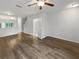 Open-concept living room features new floors, fresh paint, ceiling fan, and an attached half bathroom at 1238 Standridge Dr, Wesley Chapel, FL 33543