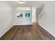 A view of a room with laminate floors, fresh paint, a staircase and a kitchen view at 1238 Standridge Dr, Wesley Chapel, FL 33543
