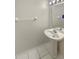 Powder room featuring a pedestal sink, tiled floor, and a mirror with overhead lighting at 1238 Standridge Dr, Wesley Chapel, FL 33543