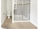 Modern bathroom featuring a glass-enclosed shower and neutral tones, perfect for relaxation at 1998 Milkweed Trce, Lutz, FL 33558