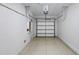 Clean, empty one-car garage offering ample space for parking and storage solutions at 1998 Milkweed Trce, Lutz, FL 33558