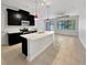 Modern kitchen with a quartz island, stainless steel appliances, and stylish pendant lighting at 1998 Milkweed Trce, Lutz, FL 33558