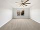 Sun-filled primary bedroom with a ceiling fan and a double window at 1998 Milkweed Trce, Lutz, FL 33558