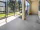 A screened patio with concrete flooring for outdoor dining and relaxation with shade at 1998 Milkweed Trce, Lutz, FL 33558