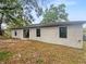 Back exterior of a home with a large backyard, offering plenty of space for outdoor activities and relaxation at 27118 Fernery Ave, Brooksville, FL 34602