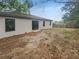 Backyard featuring a sliding glass door and ample yard space at 27118 Fernery Ave, Brooksville, FL 34602