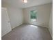 Bright bedroom featuring carpet and a window at 27118 Fernery Ave, Brooksville, FL 34602