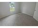 Clean, carpeted bedroom featuring a window for natural light and fresh air at 27118 Fernery Ave, Brooksville, FL 34602