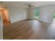 Bedroom featuring wood floors, a ceiling fan, and a window with natural light at 27118 Fernery Ave, Brooksville, FL 34602
