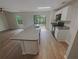 Bright kitchen featuring an island with a sink, modern appliances, and an open flow to the living area at 27118 Fernery Ave, Brooksville, FL 34602
