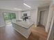 Kitchen with white cabinets, quartz countertops and stainless steel appliances at 27118 Fernery Ave, Brooksville, FL 34602