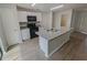Modern kitchen with stainless steel appliances, white cabinets, and an island with a breakfast bar at 27118 Fernery Ave, Brooksville, FL 34602