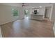 Open-concept layout with wood flooring connecting the living room and kitchen for seamless entertaining at 27118 Fernery Ave, Brooksville, FL 34602