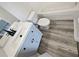 Modern bathroom features a vanity sink, laminate flooring, toilet, and combination shower and tub at 6122 Osprey Lake Cir, Riverview, FL 33578