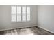This bedroom features a large window with modern blinds, neutral walls, and laminate flooring at 6122 Osprey Lake Cir, Riverview, FL 33578
