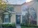 Charming two-story home with landscaped yard, lush greenery, and inviting entryway at 6122 Osprey Lake Cir, Riverview, FL 33578