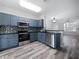 Updated kitchen includes stainless steel appliances, and an open view to the dining and living area at 6122 Osprey Lake Cir, Riverview, FL 33578