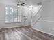 Bright living room featuring modern light fixture, plantation shutters, and sleek flooring at 6122 Osprey Lake Cir, Riverview, FL 33578
