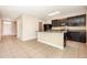 Open kitchen with dark cabinetry, granite countertops, and stainless steel appliances at 11807 Myrtle Rock Dr, Riverview, FL 33578