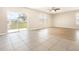 Spacious living room with a ceiling fan and sliding glass doors to the backyard at 11807 Myrtle Rock Dr, Riverview, FL 33578