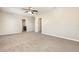 A spacious main bedroom with neutral walls, carpet flooring, ceiling fan and ensuite bathroom at 11807 Myrtle Rock Dr, Riverview, FL 33578