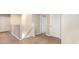 Upstairs hallway featuring modern laminate flooring and two white doors at 11807 Myrtle Rock Dr, Riverview, FL 33578