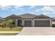 Charming single-story home with a well-manicured lawn and a two-car garage at 13581 Willow Bluestar Loop, Riverview, FL 33579