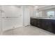 Main bathroom features a tiled walk-in shower, double vanity, and dark wood cabinets at 13581 Willow Bluestar Loop, Riverview, FL 33579