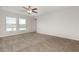 Spacious main bedroom with two windows and carpet flooring at 13581 Willow Bluestar Loop, Riverview, FL 33579