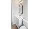 Bathroom featuring a white vanity with a framed mirror and a modern toilet at 1404 Rosewood Ave, Dunedin, FL 34698
