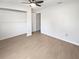 Clean bedroom with wood-look flooring, a ceiling fan, and a built-in closet at 1404 Rosewood Ave, Dunedin, FL 34698