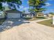 Charming single-story home with a spacious driveway and a well-maintained front yard at 1404 Rosewood Ave, Dunedin, FL 34698