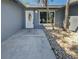Close-up of the home's front entry featuring a decorative door and stone landscaping at 1404 Rosewood Ave, Dunedin, FL 34698