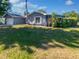 Beautiful home featuring a well-maintained lawn and mature landscaping at 1404 Rosewood Ave, Dunedin, FL 34698