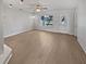 Bright living room featuring modern flooring, a ceiling fan, and a large window, creating a welcoming atmosphere at 1404 Rosewood Ave, Dunedin, FL 34698