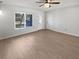 Cozy living room showcasing neutral walls, wood floors, and natural light from a window at 1404 Rosewood Ave, Dunedin, FL 34698