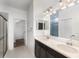 Primary bathroom with double vanity, sleek mirrors, modern lighting, and a glass-enclosed shower at 5710 Colony Glen Rd, Lithia, FL 33547