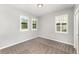 This carpeted bedroom features neutral walls, a closet, and three shuttered windows providing ample natural light at 5710 Colony Glen Rd, Lithia, FL 33547