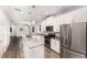 Open-concept kitchen boasts stainless steel appliances, granite countertops, and wood-look flooring at 5710 Colony Glen Rd, Lithia, FL 33547