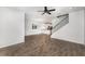 Open living area featuring wood-look floors, a ceiling fan, and natural light from shuttered windows at 5710 Colony Glen Rd, Lithia, FL 33547
