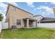 A fully fenced backyard featuring a well maintained lawn and a covered patio at 13417 Lake Monroe Pl, Riverview, FL 33579
