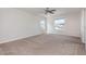 Spacious bedroom with dual windows and a ceiling fan, designed for comfort and relaxation at 13417 Lake Monroe Pl, Riverview, FL 33579