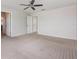 Large bedroom with neutral walls and a ceiling fan, offering a tranquil space with easy access to other areas at 13417 Lake Monroe Pl, Riverview, FL 33579