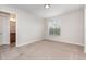 Bright bedroom featuring neutral walls, carpet, and a window, creating a serene and inviting atmosphere at 13417 Lake Monroe Pl, Riverview, FL 33579