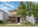 Charming two-story home featuring manicured lawn, mature landscaping, and covered porch at 13417 Lake Monroe Pl, Riverview, FL 33579